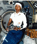 Image of a crew member working in the space shuttle in an AFS-2 suit.