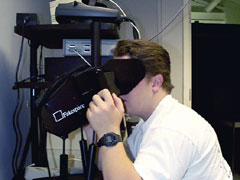 Image of research associate looking through a virtual reality display