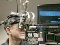 Click to watch Quicktime video of researcher wearing a virtual reality helmet.