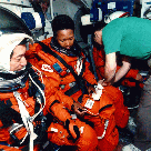 Image of two crewmembers weaing the Orange "Launch-Entry" suits