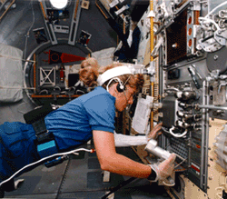 Astronaut wearing AFTE suit in the space shuttle.