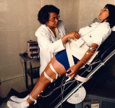 Image of Dr. Patricia Cowings working with a research subject on the tilt table.