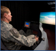 A U.S. Air Force Officer is using the Operational Based Vision Assessment (OBVA) flight simulator [click to view image galleries]
